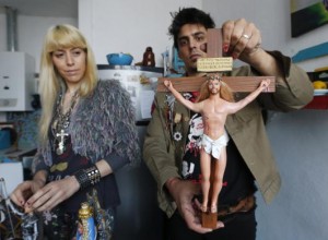 Artist Emiliano Paolini and his partner Marianela Perelli, show their 'Ken' doll that they have re-designed into the religious figure of Jesus Christ at their workshop in Rosario, north of Buenos Aires